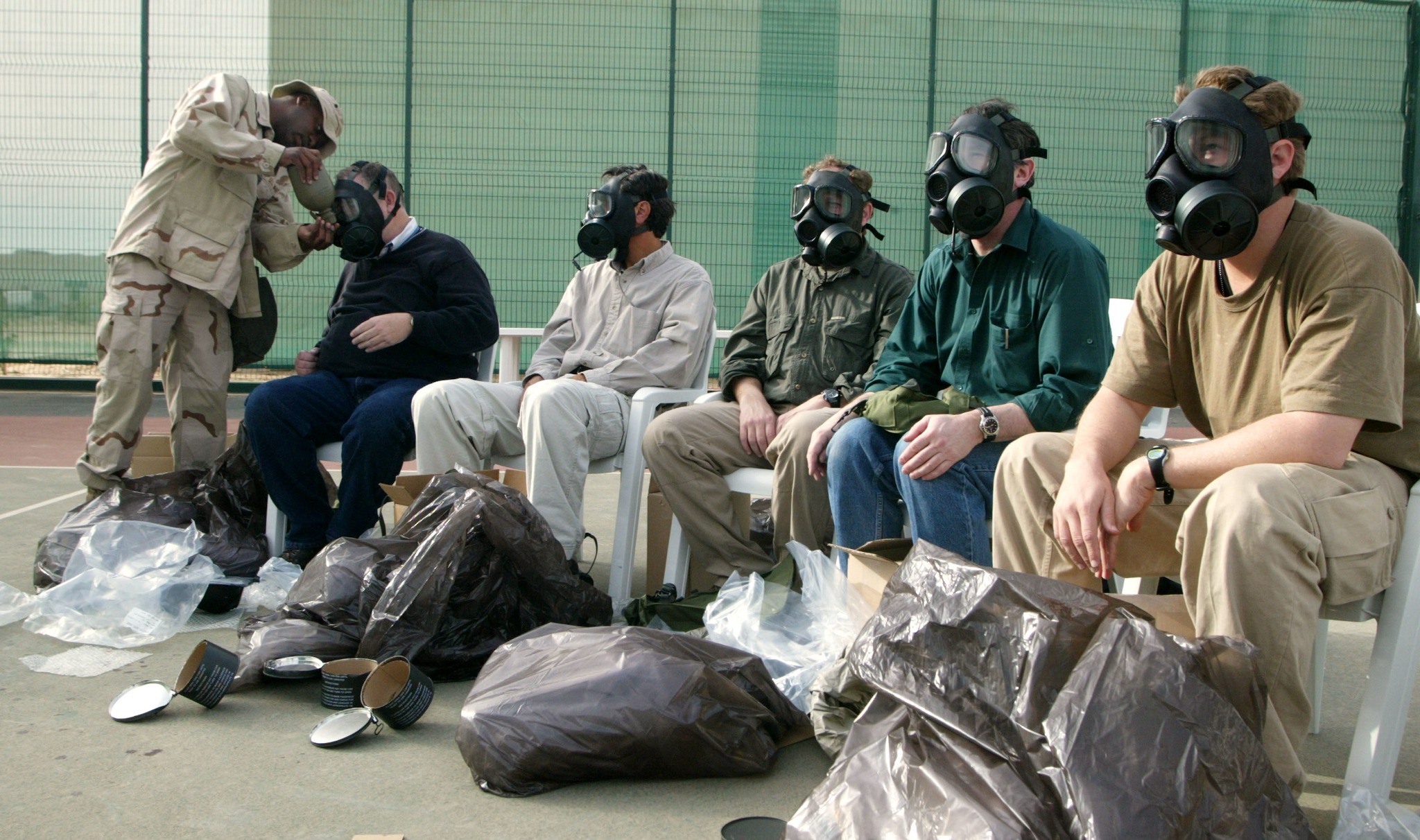 A soldier fits Western journalists with gas masks before the 2003 invasion of Iraq. More than 600 journalists were embedded in military units. (Photo: Joe Raedle / Getty)