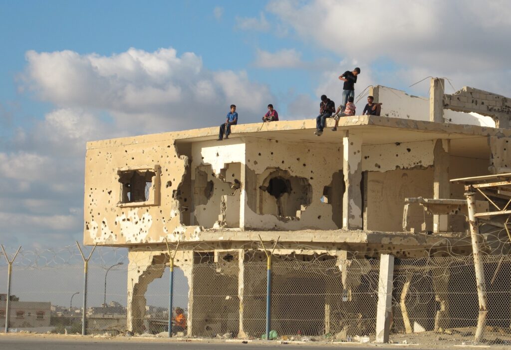 Children play atop a bullet-riddled building in Gaza, 2011 (Photo: Shareef Sarhan / UN)