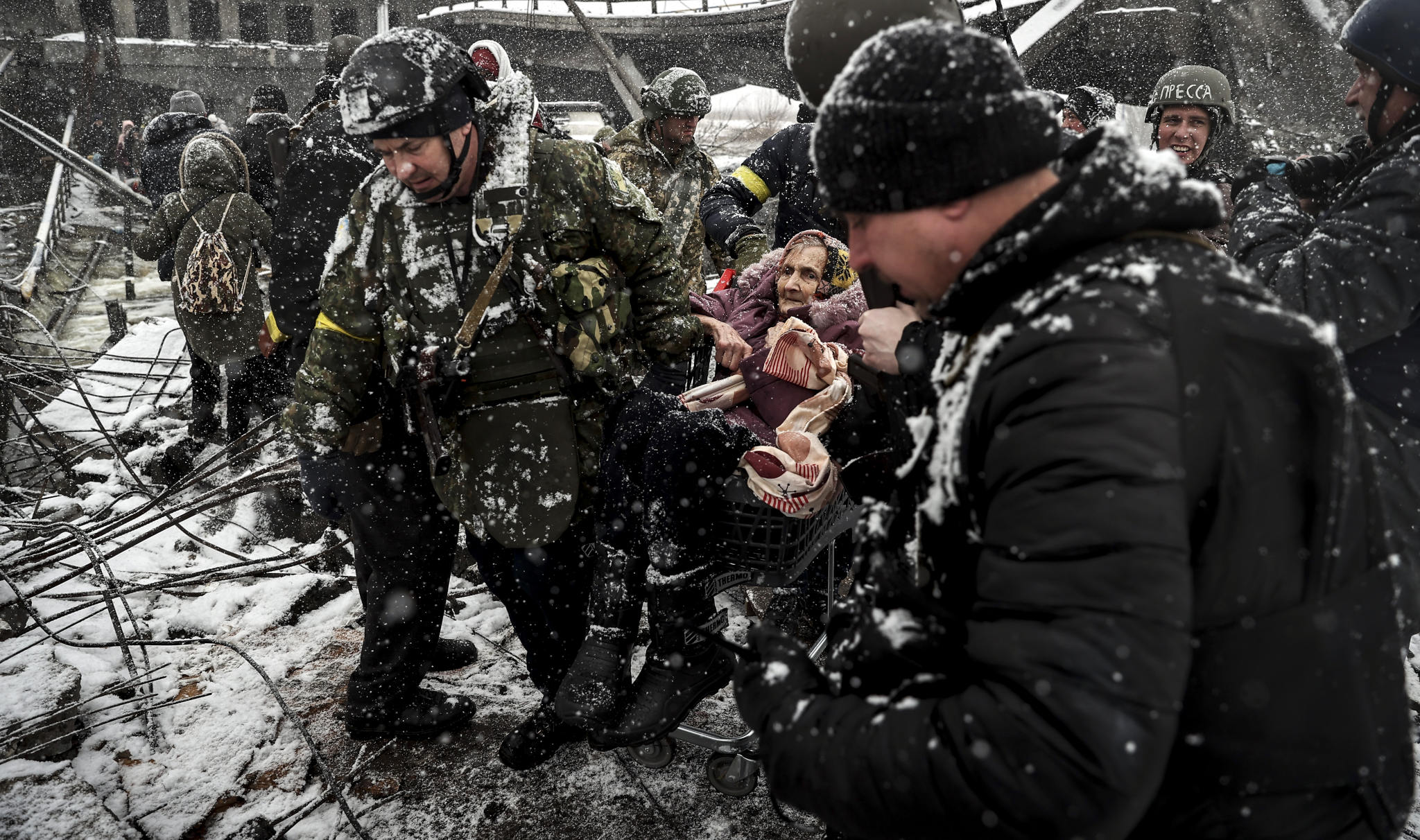 An elderly woman is evacuated in a shopping trolley from Irpin, Kyiv. (Photo: Emin Sansar / Anadolu Agency via Getty)