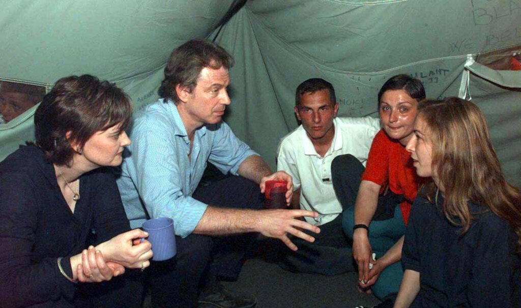 Tony and Cherie Blair meet Kosovar refugees in Macedonia, May 1999. (Photo: John Stillwell / Alamy)