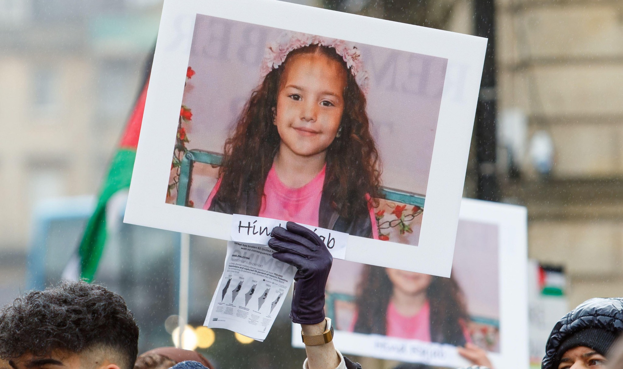 2WM81JC Bath, UK. 24th Feb, 2024. A Pro-Palestinian supporter is pictured holding up a photograph of Hind Rajab, a 6 year old girl who was found dead in Gaza almost two weeks after her family?s car reportedly encountered Israeli tanks while attempting to flee Gaza City on 29 January. The ?Stop arming Israel? protest march and rally was organised by the Bath Campaigns Network in order to allow people to show their support and solidarity with the Palestinian people and to protest about Israel's recent actions in Gaza. Credit: Lynchpics/Alamy Live New