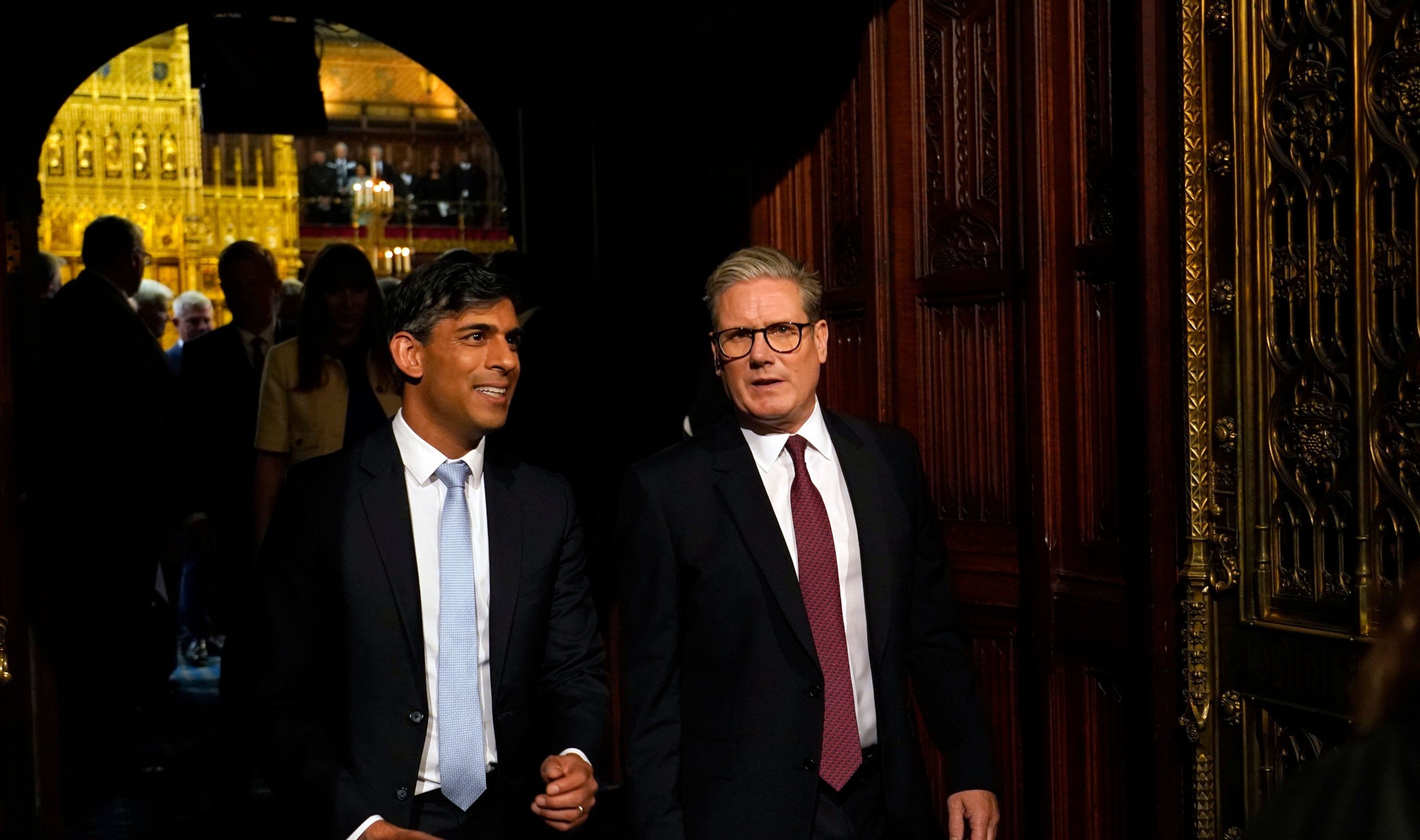 2XJ9E0Y Prime Minister Sir Keir Starmer (right) and former prime Minister Rishi Sunak (left) talk as they walk towards the House of Lords during House of Lords Chamber during the State Opening of Parliament in the House of Lords at the Palace of Westminster in London. Picture date: Wednesday July 17, 2024.