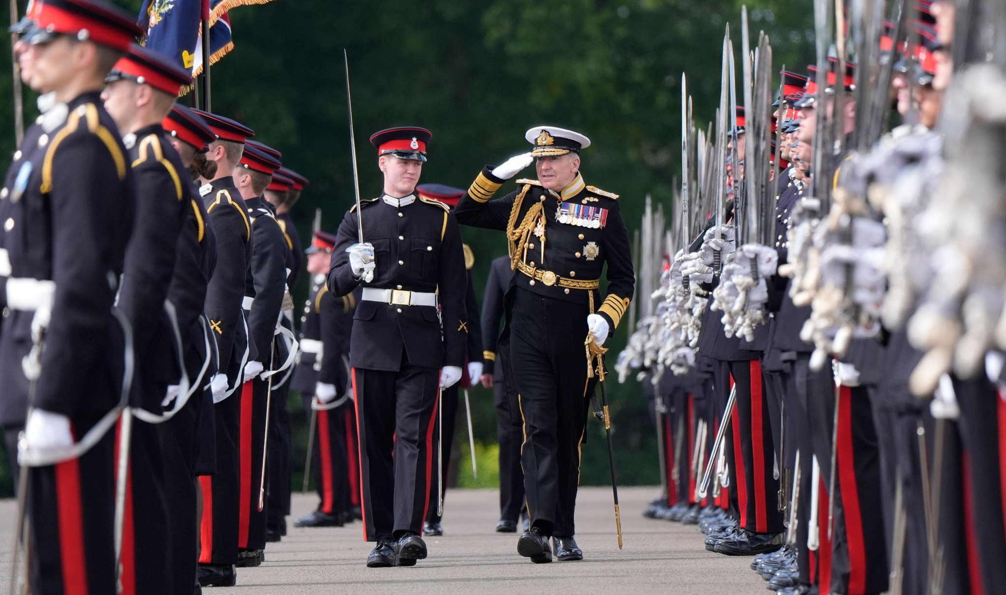 2XRAD28 Chief of the Defence Staff Admiral Sir Tony Radakin (right) inspects Officer Cadets commissioning as Army Officers during the Sovereign's Parade at the Royal Military Academy Sandhurst (RMAS) in Camberley, Surrey. Picture date: Friday August 9, 2024.