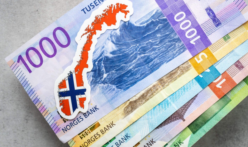 Norwegian money on a gray table top all banknotes, Norway flag, business and financial concept, close up