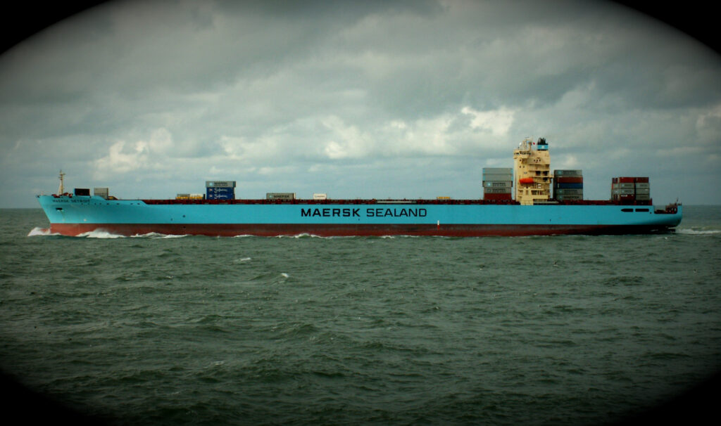 A blue hulled container ship at sea