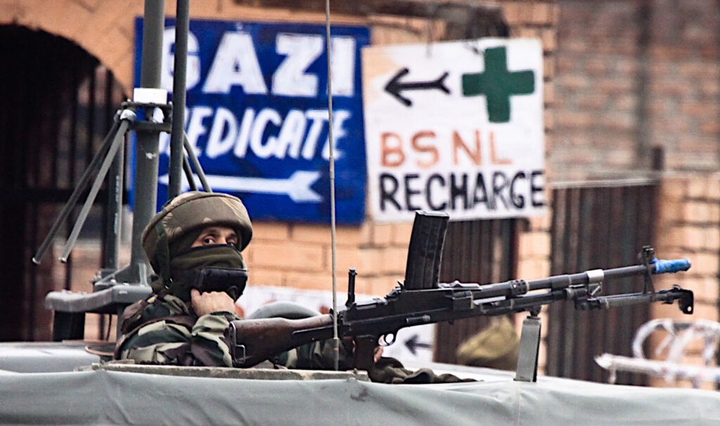 A soldier guards the roadside checkpoint outside of Srinagar International Airport (SXR) in Jammu and Kashmir, India.