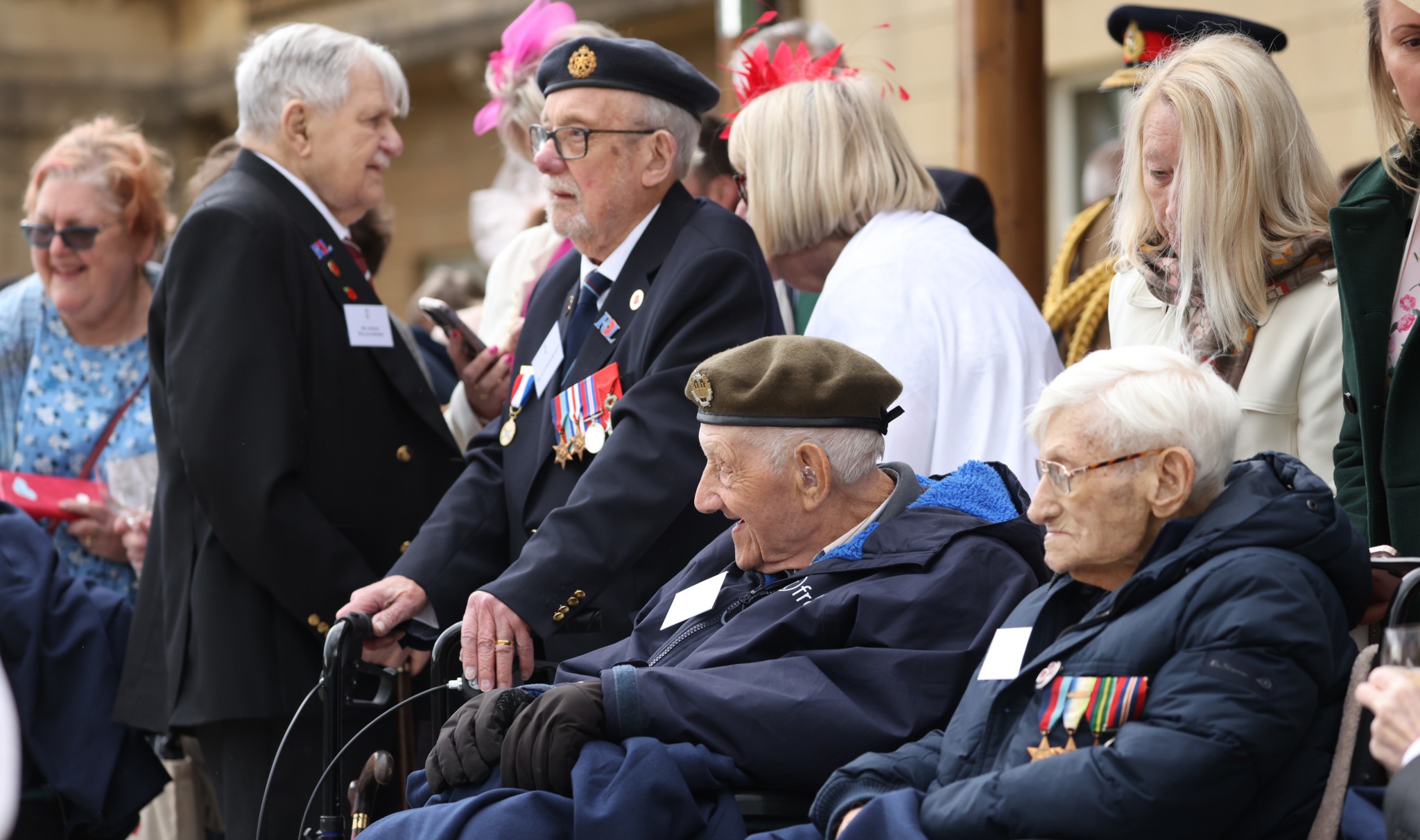Pictured: Veterans gather in the gardens of Buckingham Palace afer the military procession and flypast. A major military procession and flypast in central London has commenced the United Kingdom’s national commemorations of the 80th anniversary of the end of the Second World War in Europe – Victory in Europe Day. The procession comprising of around 1,000 members of the Armed Forces from the Royal Navy, British Army and Royal Air Force and 23 aircraft will from the Royal Air Force flypast. Ceremonies in Parliament Square will launch the procession as the Armed Forces march up Whitehall, through Admiralty Arch and down the Mall towards Buckingham Palace. Second World War veterans will join special guests at the Queen Victoria Memorial to watch the procession. Seven military bands are involved in the procession, including The Band of The Household Cavalry Mounted Regiment on horseback. The Royal Air Force flypast will include a Second World War-era Lancaster from The Battle of Britain Memorial Flight and modern aircraft which have recently served on operations protecting the UK around the world. The flypast will culminate in a spectacular display by The Royal Air Force Aerobatic Team – The Red Arrows – complete with their iconic red, white and blue smoke. The UK Armed Forces will also take a leading role in VE Day 80 commemorations in Edinburgh, Belfast and Cardiff.