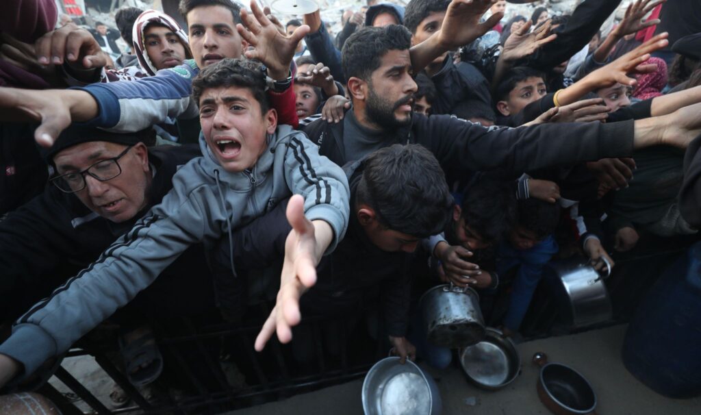 People try to receive food relief, Gaza City, 4 March 2025 (Mahmoud Zaki/Xinhua/Alamy Live News)