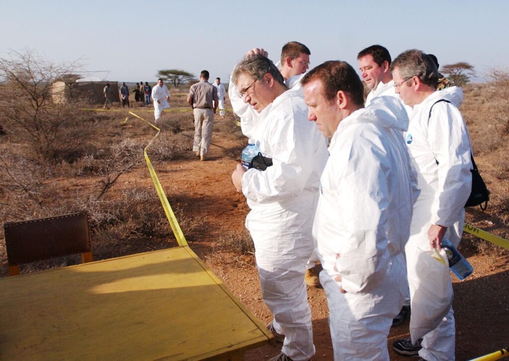 British forensic experts at the burial site. (Photo: Sayyid Azim / Alamy)